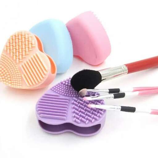 a group of different colored sand brushes sitting on top of a white surface.