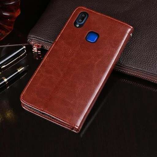a brown leather cell phone case sitting on a table.