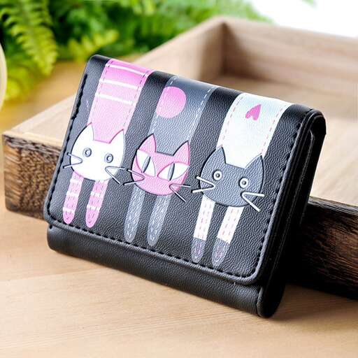 a small black and white cat purse with a pink and white cat design.