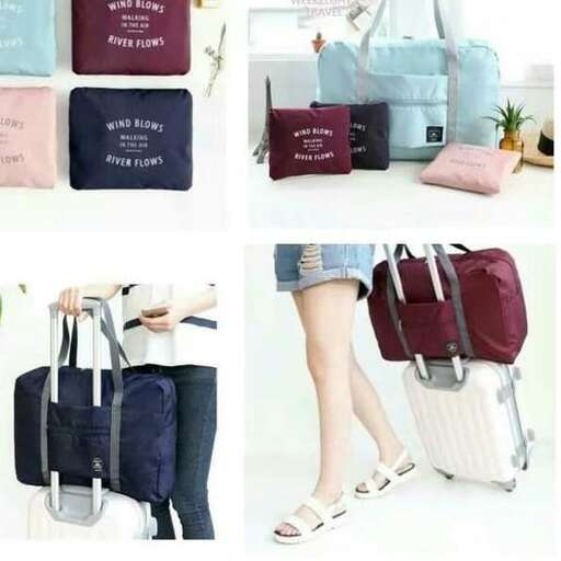 a woman carrying a suitcase and a bag.