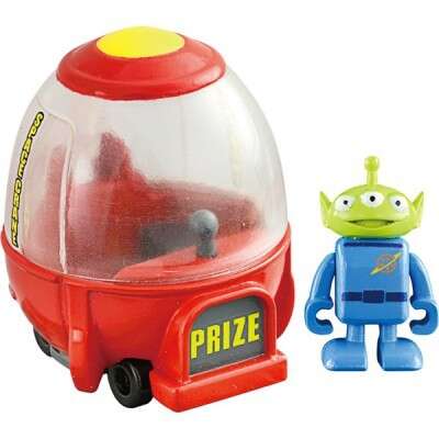a plastic toy with a blue alien head and a red plastic toy.
