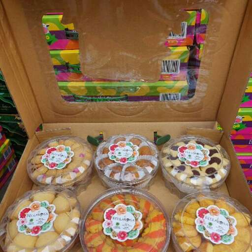 a box of colorful cookies with a box of candy.