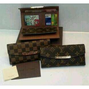 a suitcase and a wallet on a table.
