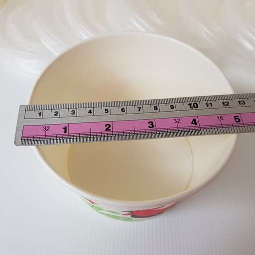 a measuring cup with a measuring tape in it.