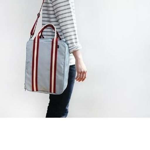 a woman carrying a bag in a bag.