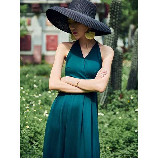 actor in a green dress and hat