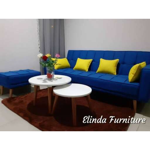 a living room with a blue couch and a coffee table.