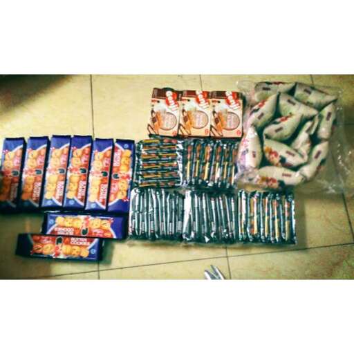 a bunch of bags of food sitting on a tile floor.