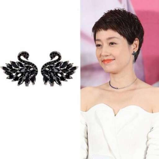 actor wears a white dress with black feathers