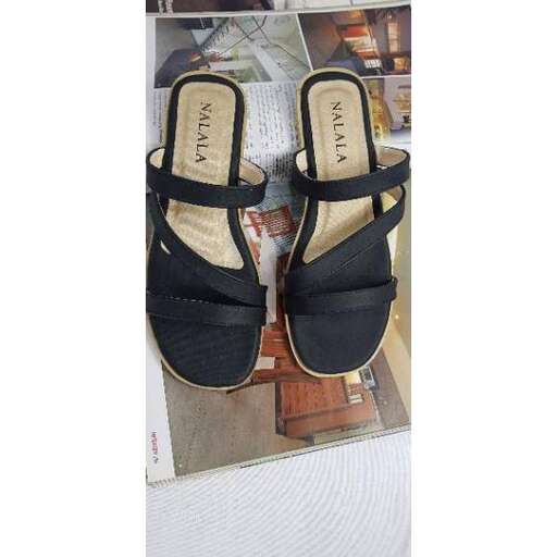 a pair of black sandals with a gold buckle.