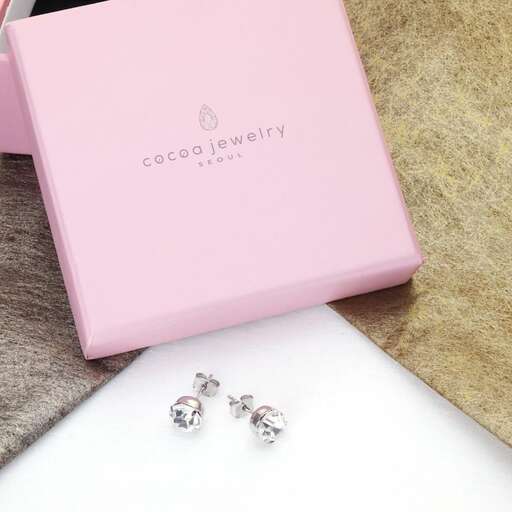 a box of earrings in pink