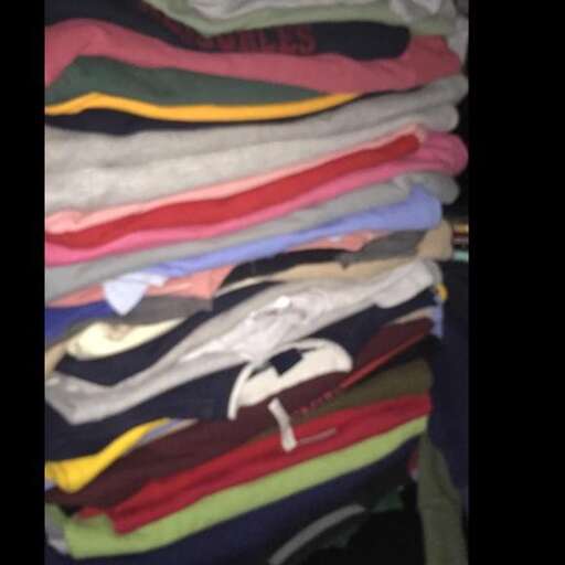 a stack of colorful t - shirts.