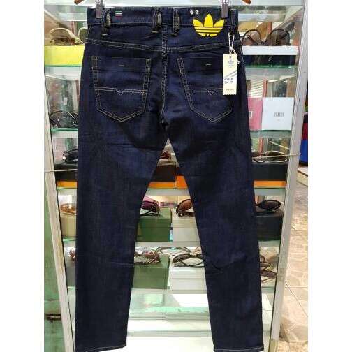 a pair of men's jeans with a yellow logo on the front.