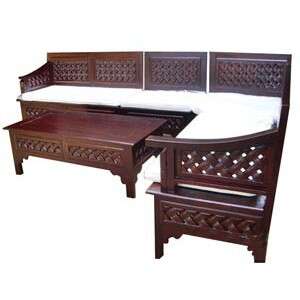 a bed with a bench and a blanket.