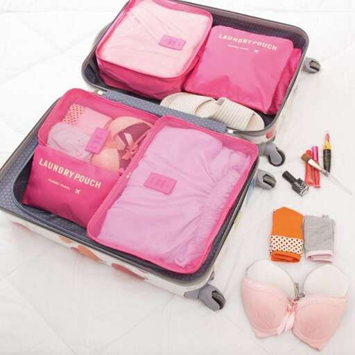 a suitcase with a baby in it and other items in it.