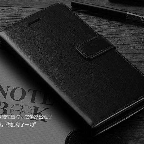 a black and white photo of a cell phone and a pen.