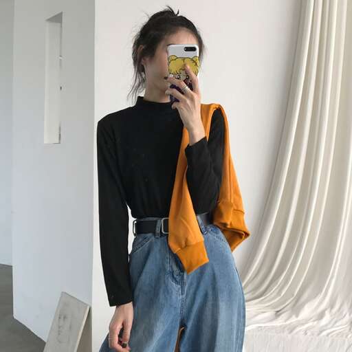 a model wearing a black turtleneck and jeans.