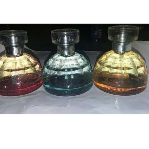 a set of 3 - bottle glass bottles with colored liquid.