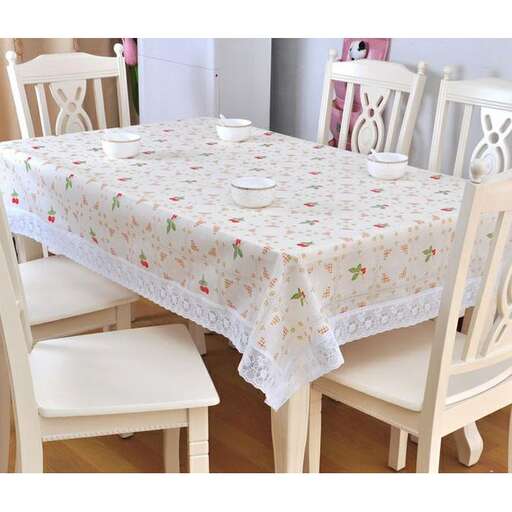 a table with a tablecloth on it and a coffee mug on it.