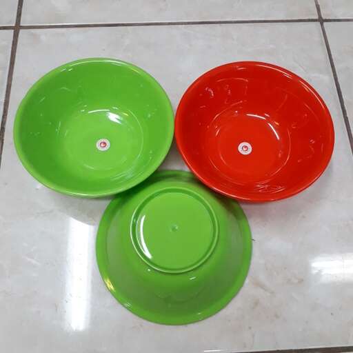 a pair of green and red bowls with a white stripe.