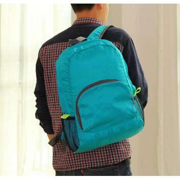 a man carrying a backpack in a room.