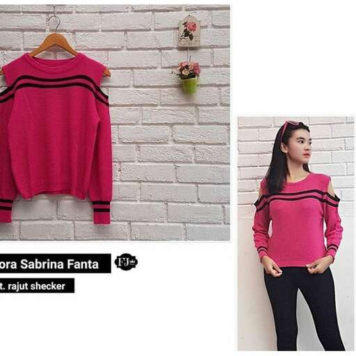 pink and black striped sweater with black stripes and a white brick wall