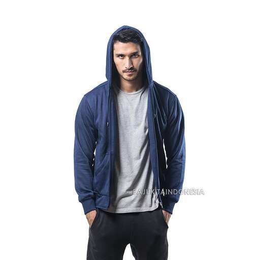 portrait of a young man in a blue hoodie