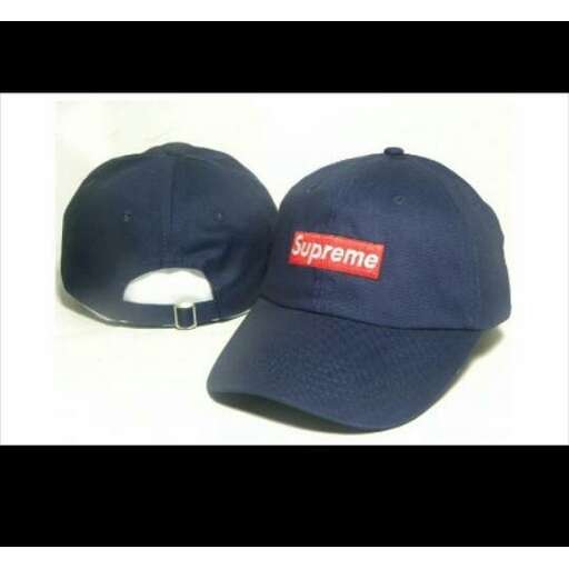 a blue baseball cap with a red logo on it.