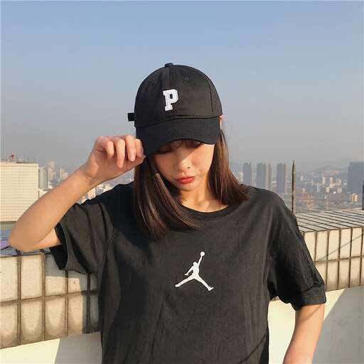 a girl in a baseball cap and a baseball cap
