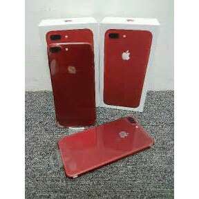 two red and white cell phones sitting on a carpet.