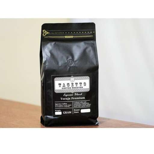 a black coffee bag with a white label.