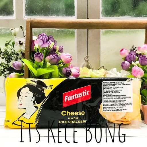 a box of cheeses sitting on a table next to a window.