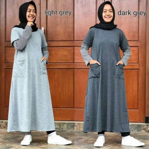 the dress is a long sleeved dress with a long skirt and white shoes.