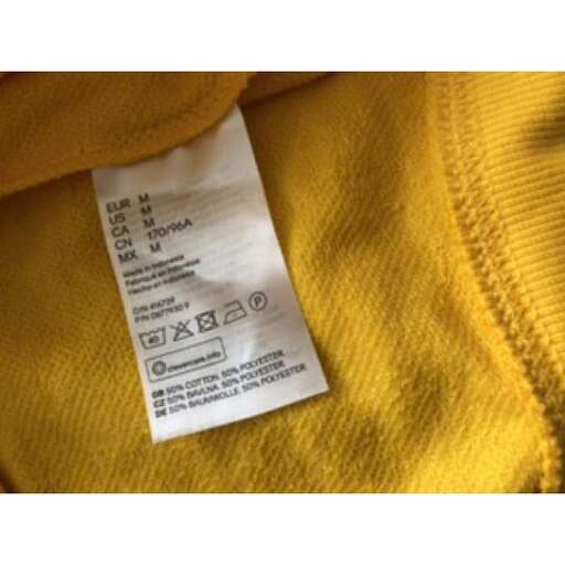 a close up of a receipt on a yellow shirt.