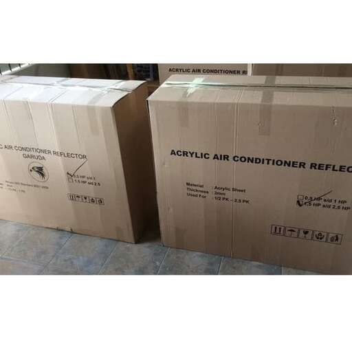 a stack of cardboard boxes sitting on top of a tile floor.
