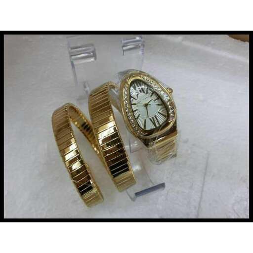 a gold and white gold ring with a clock on it.