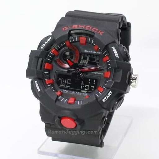 the watch is made of black plastic and has red and black details.