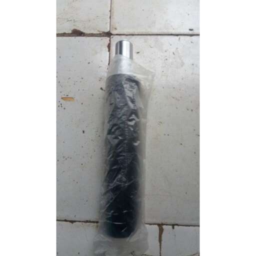a large tube laying on the floor with plastic wrap around it.