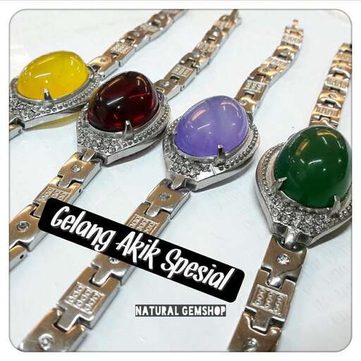a bracelet with a colorful stone set on a silver watch.