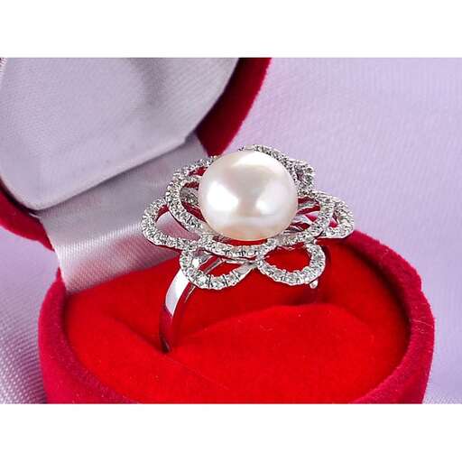 a diamond ring in sterling silver with a pearl and a pearl.