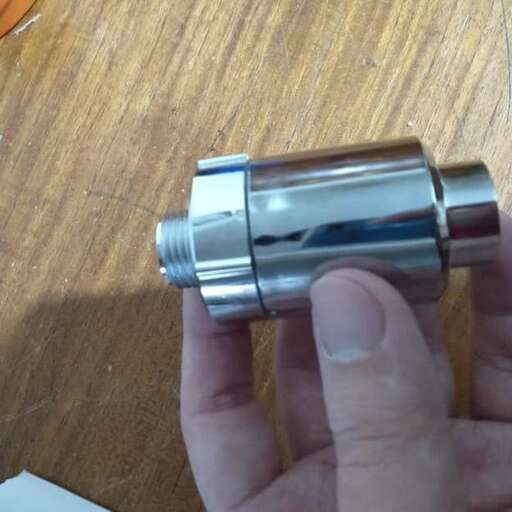 a person holding a small object in their hand.