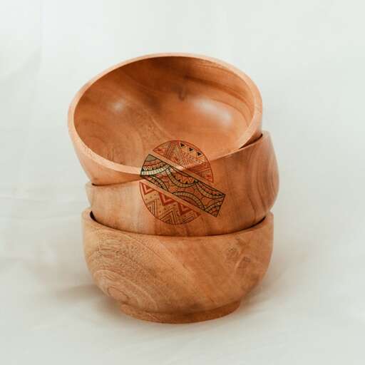 a wooden bowl with a design on it.