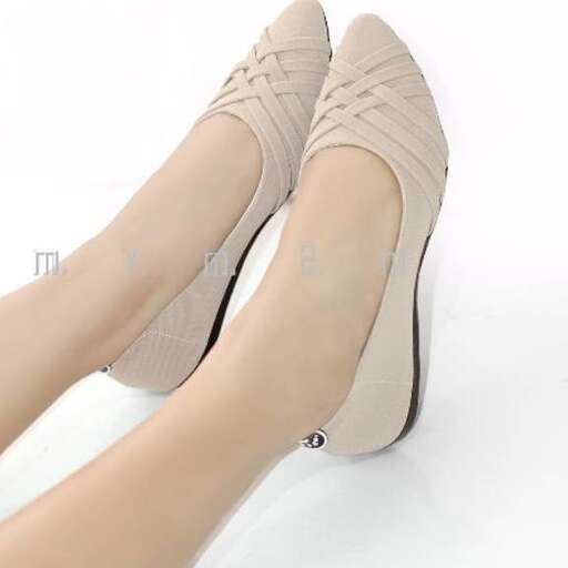 a pair of tan high heeled shoes with a thin heel.