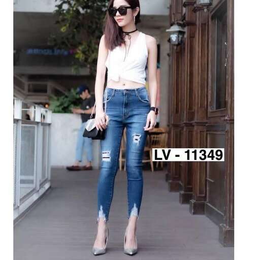 a white tank top and jeans.