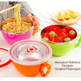 a woman is eating strawberries and oranges.