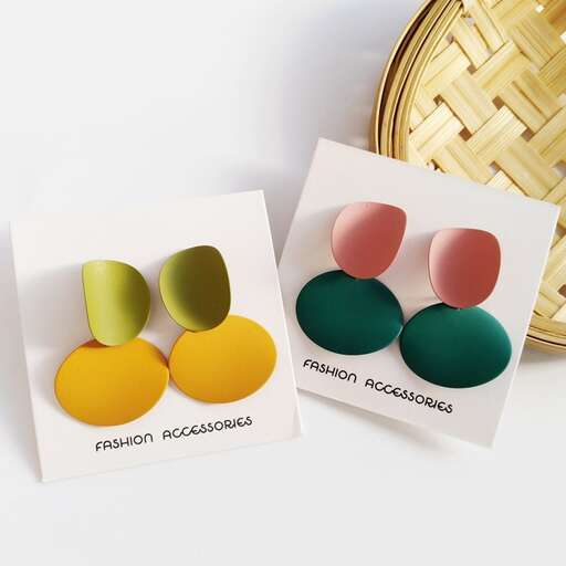 a set of three colorful buttons in a box.