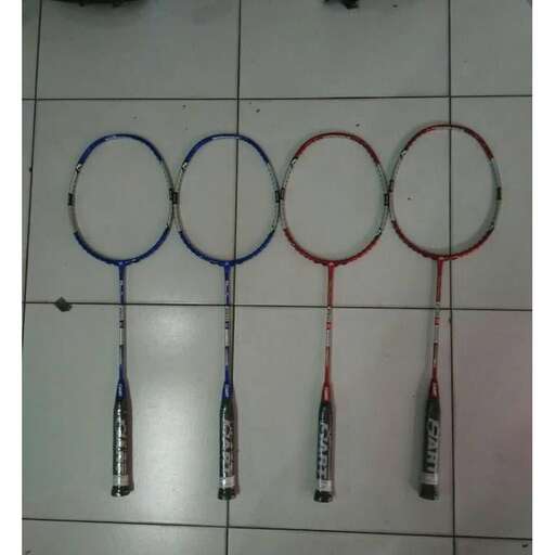 a pair of scissors hanging on a tile floor.