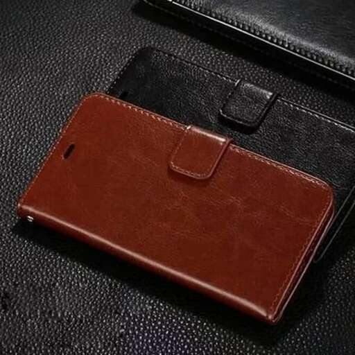 a brown leather wallet sitting on top of a black surface.