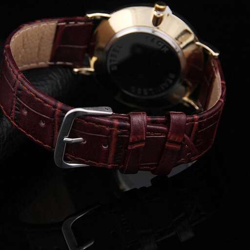 a brown leather belt with a watch on it.