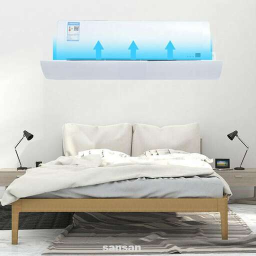 a bed with a white sheet and a blue picture on the wall.